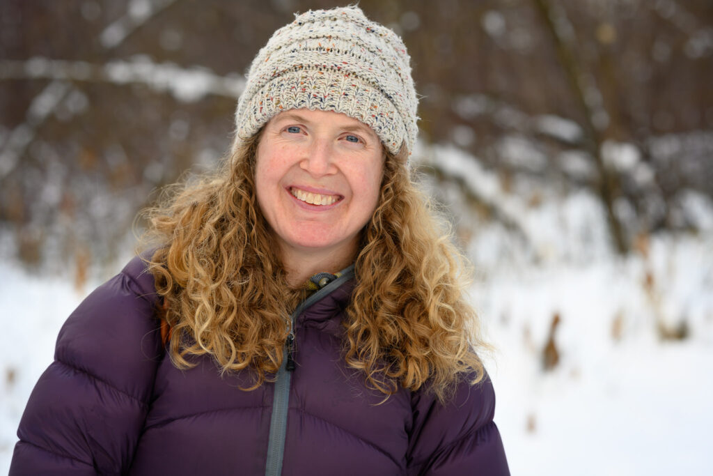 Portrait photograph of a smiling woman.